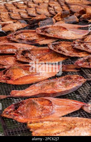 Selling various smoked fish in a street food market in Vilnius, Lithuania, Europe, close up, vertical Stock Photo