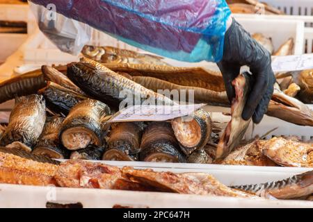 Selling various smoked fish in a street food market in Vilnius, Lithuania, Europe, close up Stock Photo