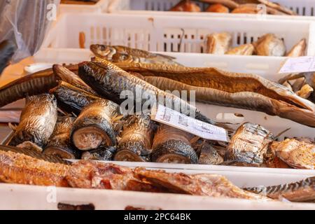 Selling various smoked fish in a street food market in Vilnius, Lithuania, Europe, close up Stock Photo