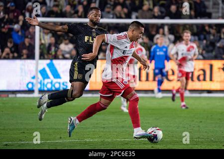 New England Revolution forward Bobby Wood (17) gets past Los Angeles FC midfielder Kellyn Acosta (23) during a MLS match, Sunday March 12, 2023, at th Stock Photo