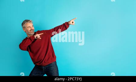 Cool middle aged man pointing at copy space, panorama Stock Photo
