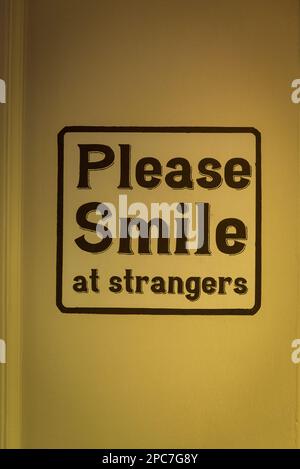 Please smile at strangers sign, Kingly Court, Soho, London, England, UK Stock Photo