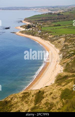 View of coastline with bay, beach, farmland and village, from White Nothe, Dorset, England, United Kingdom Stock Photo