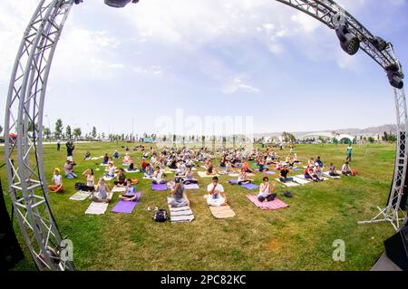 Baku, Azerbaijan, may 20, 2019: men and women practice yoga in a Park on a green glade Stock Photo