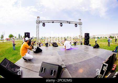 Baku, Azerbaijan, may 20, 2019: men and women practice yoga in a Park on a green glade. Stock Photo