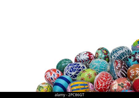 A collection of colorful Easter eggs arranged close together in the lower corner of the frame. Stock Photo