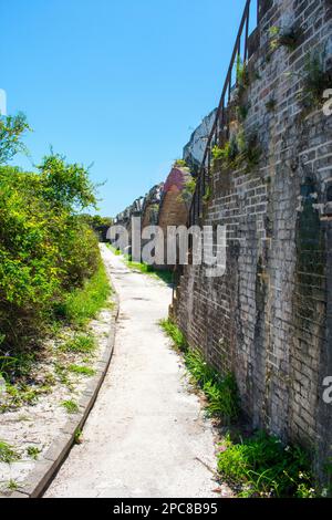 Curved walkway following the brick walls inside Fort Pickens Stock Photo