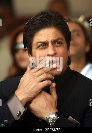 Bollywood actor Shahrukh Khan smokes as he watches the Tag