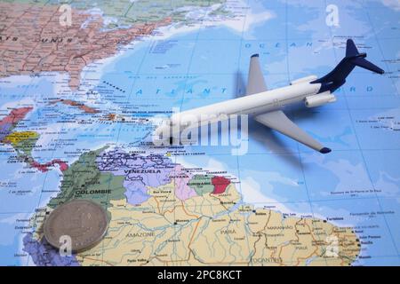 Caracas, Venezuela - September 19 2018: Composition made of a world map centered in Central America with on it, a toy plane and a Venezuelan bolívar c Stock Photo