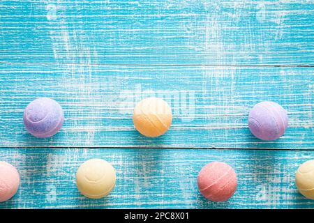 Multicolored bath bombs on a blue wooden background, top view. Stock Photo