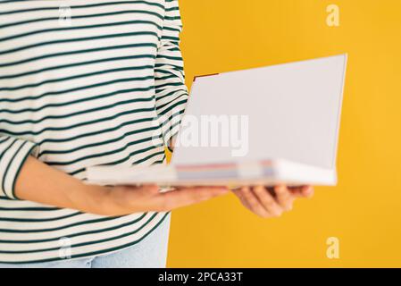 Opened book in hands isolated on white background. Stock Photo