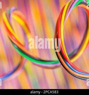 Close-up shot of coiled multi-colored narrow gauge electrical wires. For colour identification, electrical complexity. Stock Photo