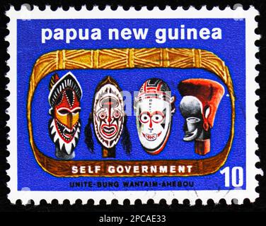 MOSCOW, RUSSIA - FEBRUARY 15, 2023: Postage stamp printed in Papua New Guinea shows Native carved heads, Self-government serie, circa 1973 Stock Photo