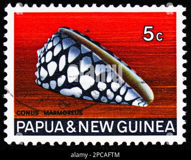 MOSCOW, RUSSIA - FEBRUARY 15, 2023: Postage stamp printed in Papua New Guinea shows Marbled Cone (Conus marmoreus), Seashells Definitives serie, circa Stock Photo