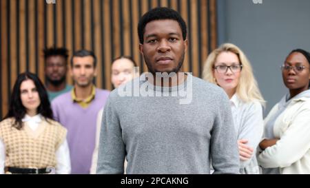 Handsome cheerful african american executive businessman against the background of diverse people Stock Photo