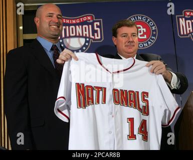 Washington Nationals General Manager Jim Bowden, right, holds up a jersey  during a news conference introducing Manny Acta as the baseball team's new  manager in Washington, Tuesday, Nov. 14, 2006. (AP Photo/Lawrence
