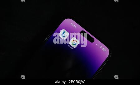 Ai war, Bing vs Google. Google vs Microsoft, Bard vs ChatGPT. Iphone 14 pro max in the dark background. Stock Photo
