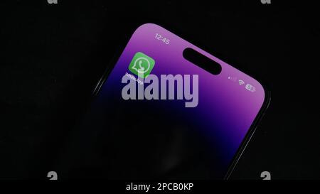 Whatsapp Mobile Application on the iPhone 14 Pro max Screen. CloseUp Studio Shot phone in the dark background. Stock Photo