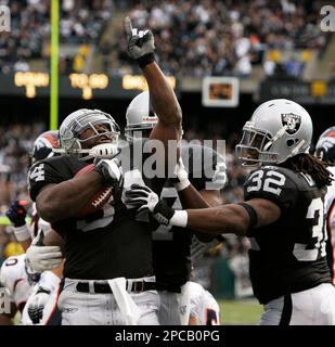 Cincinnati, United States. 14th Sep, 2003. Cincinnati Bengals linebacker  Riall Johnson shakes hands with Oakland Raiders running back Zack Crockett  after coin toss.The Raiders defeated the Bengals, 23-20, at Network  Associates Coliseum