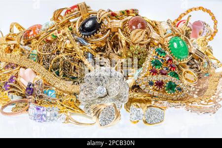 Horizontal shot of a cluster of colorful vintage jewelry on a white background. Stock Photo