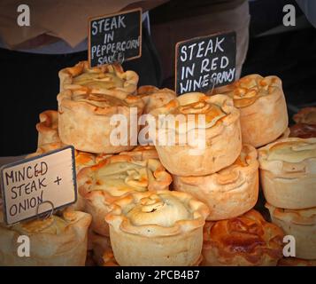 Quality artisan steak pies, Steak in red wine gravy, Steak in peppercorn sauce, minced steak and onion etc, at Warrington artisan market, Cheshire Stock Photo