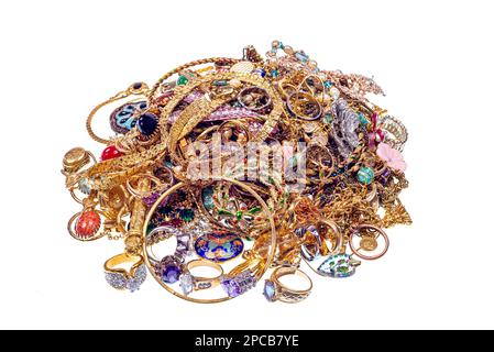 Horizontal shot of a pile of vintage gold jewelry isolated on white. Stock Photo