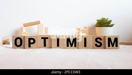 Optimism Word Written In Wooden Cube. Stock Photo