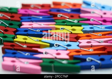 Folded multi-colored clothespins on the table Stock Photo