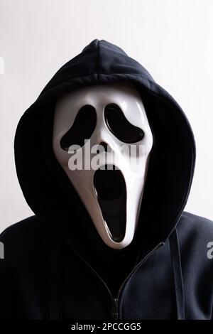 Packshot of Mask. An anonymous man with a white mask and a hood on the head Stock Photo
