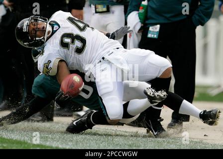 Jacksonville Jaguars' Brian Iwuh (59) and Jorge Cordova (58) pummel  Philadelphia Eagles punter Dirk Johnson after he punted the ball at Lincoln  Financial Field in Philadelphia, Pennsylvania, Sunday, October 29, 2006. The