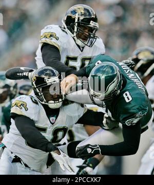 Jacksonville Jaguars' Brian Iwuh (59) and Jorge Cordova (58) pummel  Philadelphia Eagles punter Dirk Johnson after he punted the ball at Lincoln  Financial Field in Philadelphia, Pennsylvania, Sunday, October 29, 2006. The