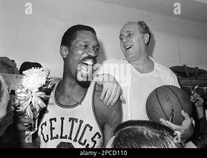 Coach Red Auerbach (left) of the Boston Celtics, huddles with his