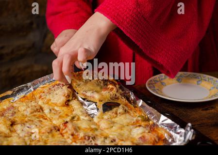 Premium Photo  Woman holding spatula with piece of spinach lasagna over  baking dish