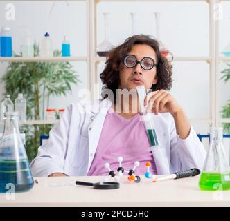 The funny male chemist working in the lab Stock Photo