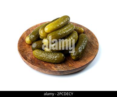 Pickled Cucumbers on Wood Plate Isolated. Fermented Food, Marinated Canned Vegetables, Gherkins, Pickled Cucumbers on White Background Stock Photo