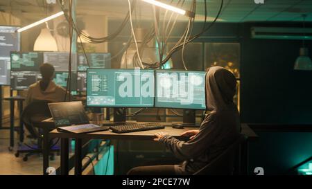 Man creating breach of security after gaining unauthorized access to system, hacking computer to steal government data. Hacker doing hacktivism work, ransomware and identity theft concept. Stock Photo