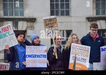 London, UK. 13th Mar, 2023. Protesters hold placards in support of junior doctors during the demonstration outside Downing Street. Thousands of junior doctors and supporters gathered to demand full pay restoration for junior doctors as they begin their 72-hour strike. Credit: SOPA Images Limited/Alamy Live News Stock Photo