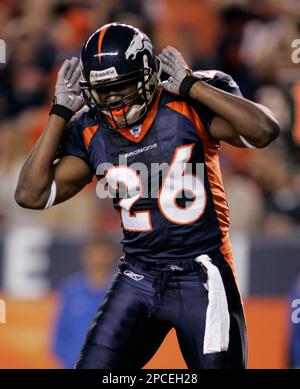 Tennessee Titans Keith Bulluck (53) attempts to tackle Denver Broncos  running back Tatum Bell (26) at Invesco Field at Mile High in Denver,  Colorado, Saturday, August 19, 2006, in NFL preseason action. (