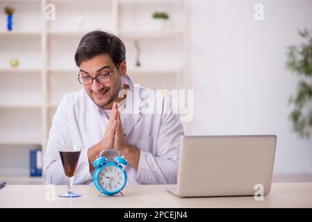 Young chemist examining soft drink at the lab Stock Photo