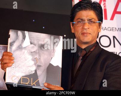 Bollywood actor Shahrukh Khan holds his biography Still Reading 