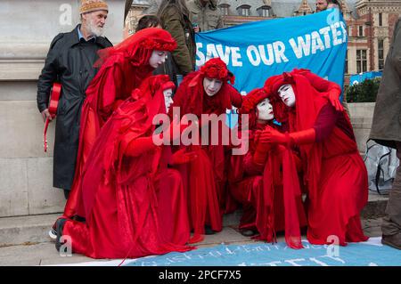 London, UK. 13th March, 2023. The Red Rebels Brigade (pictured) joined embers of Stop HS2, HS2 Rebellion, Dirty Water Campaign, Extinction Rebellion and the Hillingdon Green Party in Parliament Square today to demand action from MPs to protect our seas and rivers from contamination. In particular, HS2 have been boring into the chalk acquifer in the Colne Valley as part of the HS2 High Speed Rail construction work. Environmentalists have concerns about the possible adverse impact the HS2 work is having on some of the drinking water supplies to London. Credit: Maureen McLean/Alamy Live News Stock Photo