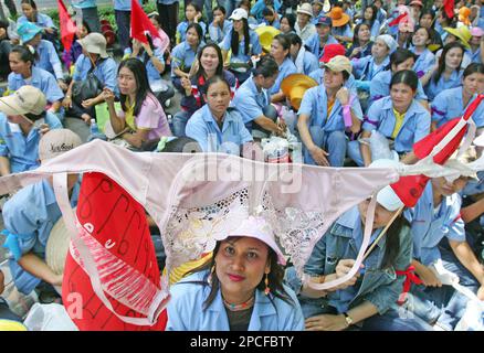 A protester hoists a bra as about 500 workers from a Thai Bra factory that  manufactures bras for Victoria's Secret, The Gap and other American  companies march outside the U.S. Embassy in Bangkok, Thailand, on Sunday,  Oct. 8, 2006 to request help with a