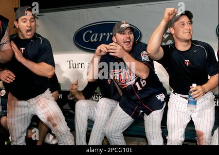 Minnesota Twins' Nick Punto (8) and Carlos Gomez, right, celebrate the Twins'  5-3 win over the Chicago White Sox during a baseball game Tuesday, July 28,  2009, in Minneapolis. (AP Photo/Tom Olmscheid