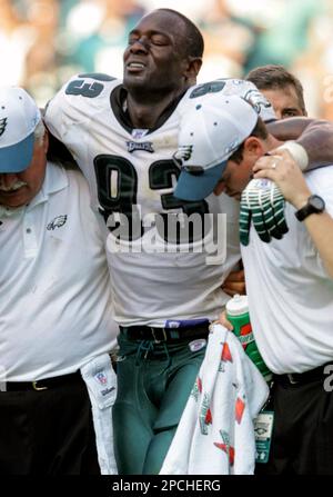 Philadelphia Eagles defensive end Jevon Kearse (93) grabbs hold of New York  Giant running back Derrick Ward before tackling him in the third quarter at  Giants Stadium in East Rutherford, New Jersey