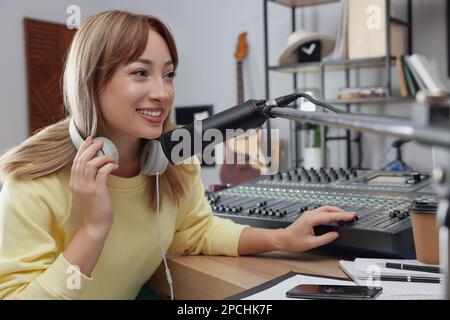 Woman working as radio host in modern studio Stock Photo