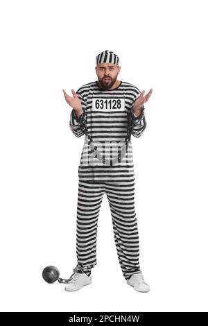 Prisoner in special uniform with chained hands and metal ball on white background Stock Photo