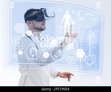 Medical technology concept. Doctor using virtual reality headset to study health data of patient Stock Photo