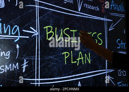 Business trainer with pen using interactive board, closeup Stock Photo