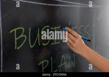 Business trainer with pen using interactive board, closeup Stock Photo