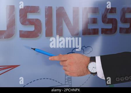 Business trainer with pen using interactive board, closeup Stock Photo